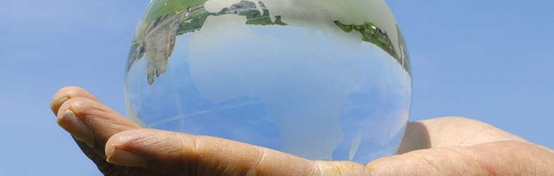 Hand holding glass globe, caring for creation