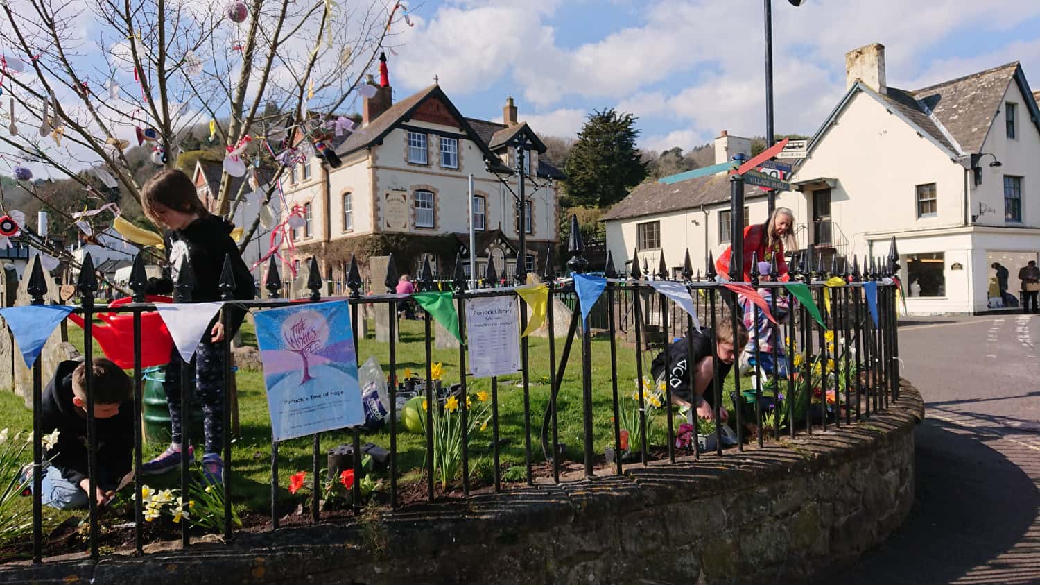 Children decorating railings in porlock