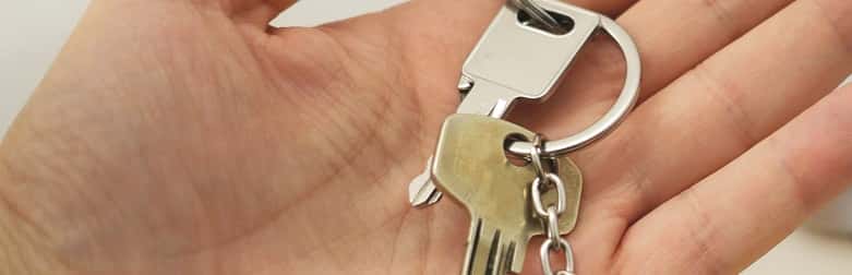 Hand holding key to the door