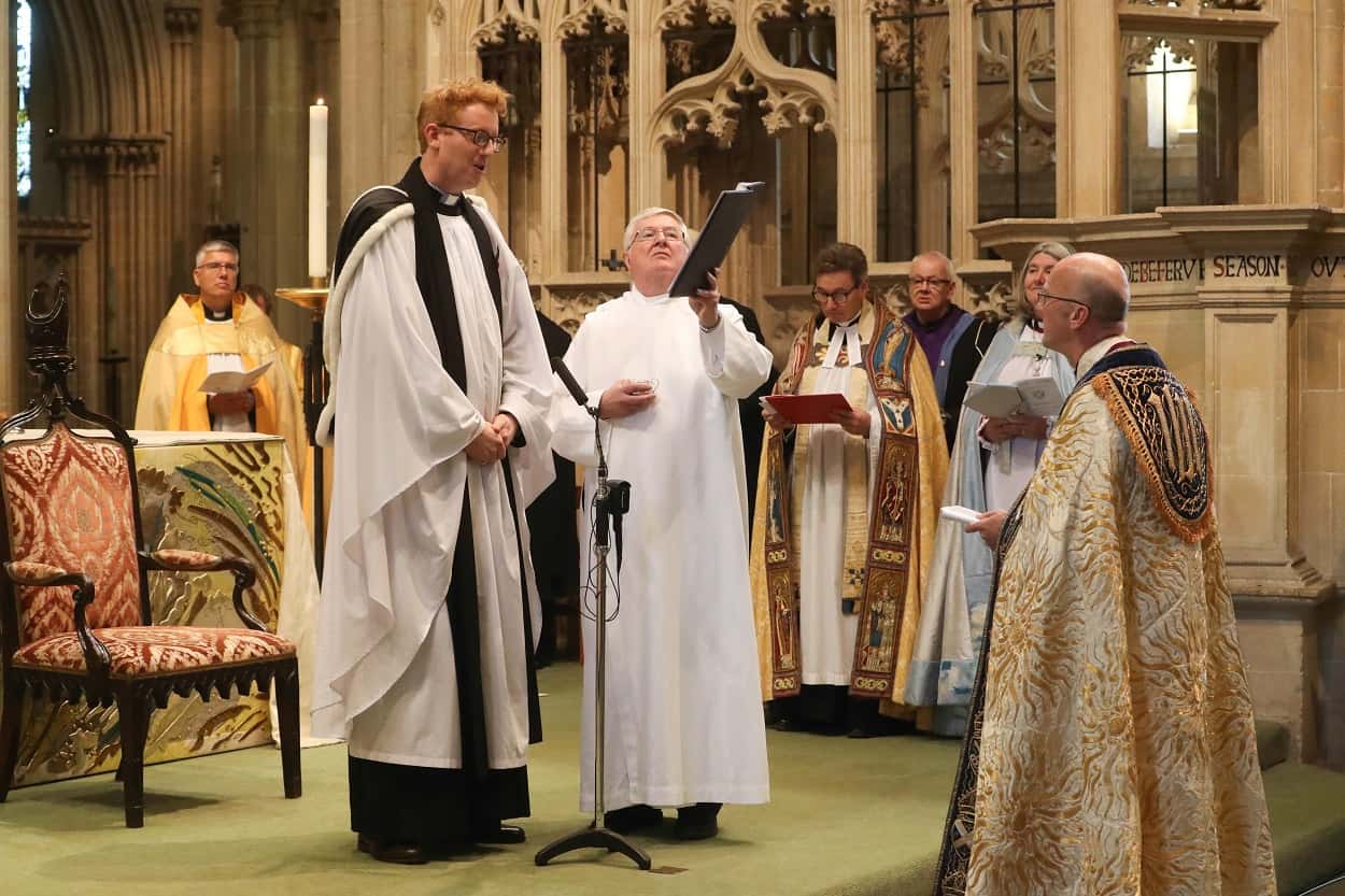 recently ordained curate and school chaplain, Revd George Beverly anoints Bishop Michael