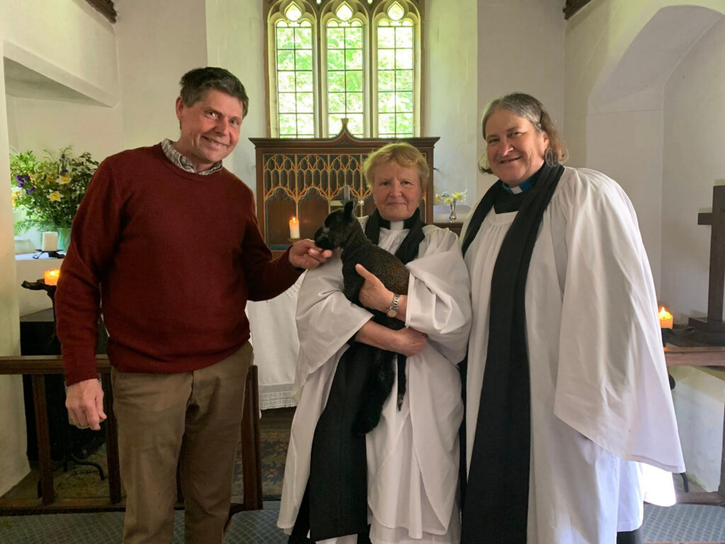 Rob Walrond, Deanery Parish and Support Adviser with clergy from Porlock and a lamb.